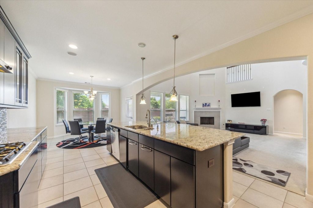 Modern kitchen with island, featured by a Licensed Real Estate Agent Sugar Land for stunning property listings.