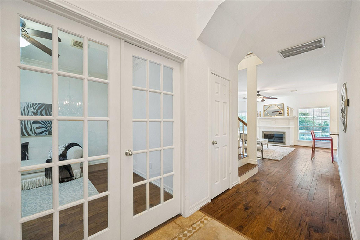 Modern home interior in Sugar Land featuring bright hallway and living room, by licensed real estate agent sugar land