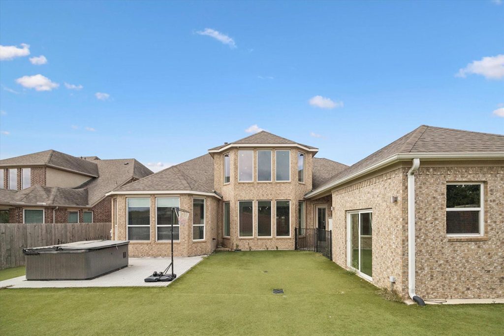 Modern Sugar Land backyard with spa, turf, and basketball hoop; estate broker sugar land for premium listings and showings