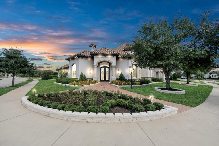 Single-story Mediterranean luxury home at sunset, tiled roof, grand double doors, pristine lawns—licensed real estate agent sugar land