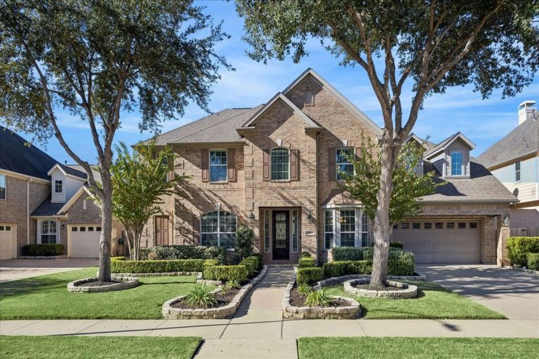 Elegant brick two-story home with manicured landscaping, double garage, and inviting entryway offered by professional Home Selling Agents Sugar Land.