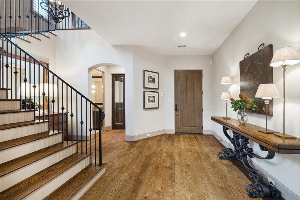 Stylish residential foyer with staircase, console table, and natural light—ideal for discussing home readiness with a realtor.