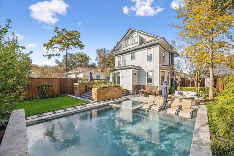 Luxurious backyard oasis featuring sparkling pool, sun deck, lounge chairs, and lush landscaping in premium property by Home Selling Agents Sugar Land.
