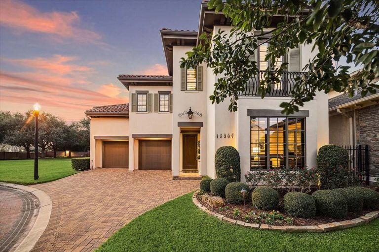 Two-story stucco home with tiled roof and manicured landscaping at sunset, perfect for early-stage buyer interest.