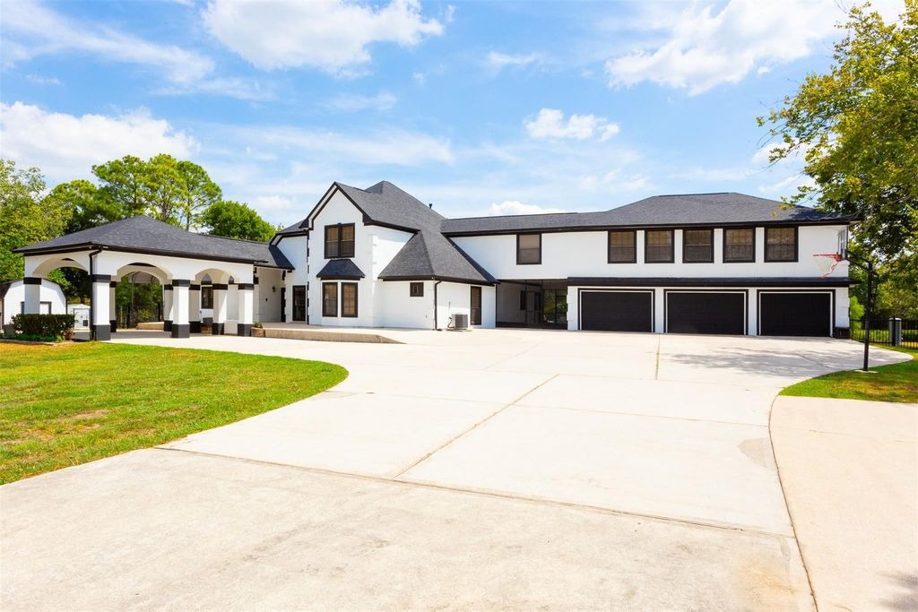 Spacious modern white brick luxury home with three-car garage and expansive driveway, listed by top Realtor in Sugar Land, TX.