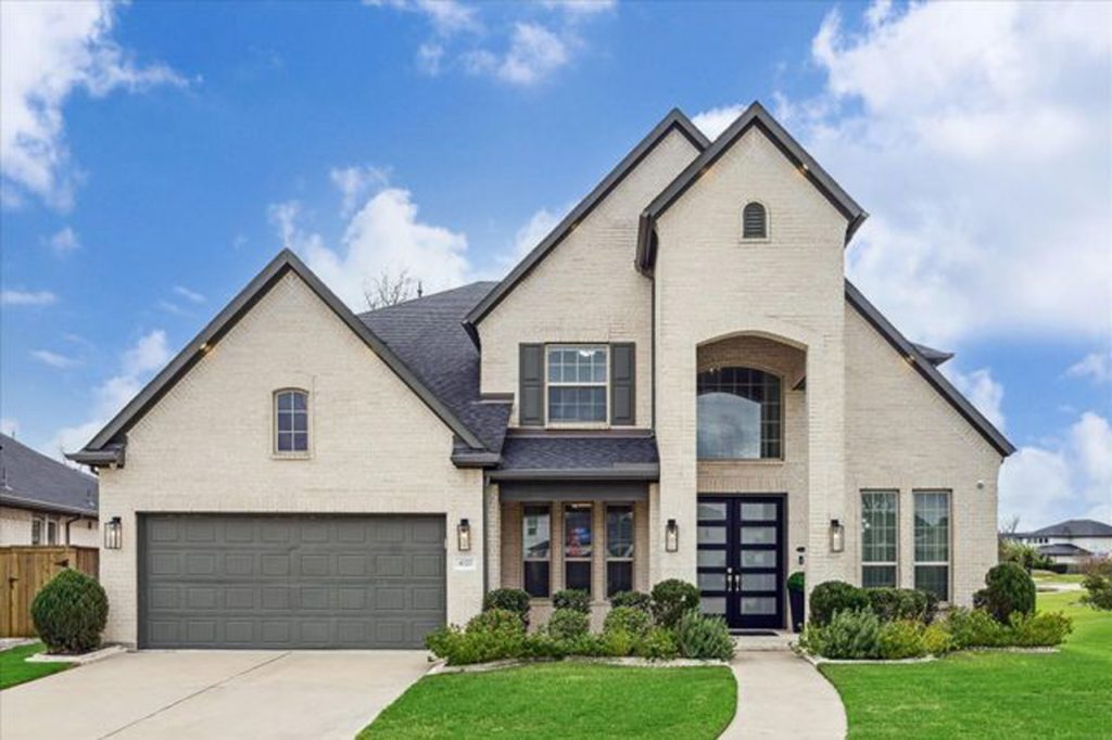 Realtor Broker Sugar Land listing featuring modern two-story brick home with arched windows and landscaped entry