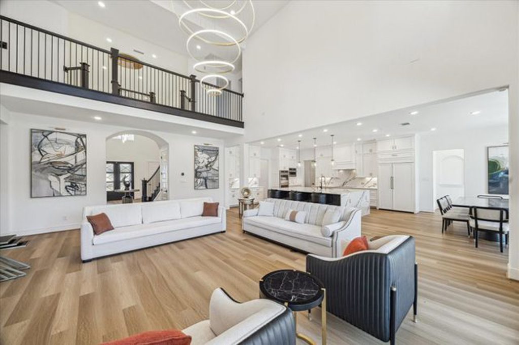Interior view of a luxury Sugar Land house living room with high ceilings and modern design, listed by a top realtor.
