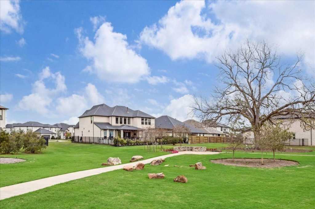 Serene suburban landscape with manicured grass, winding path, trees, and charming homes – Licensed Real Estate Agent Sugar Land