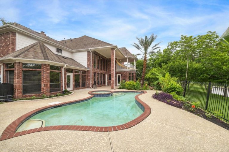 A beautiful backyard pool and patio area of a luxury estate represented by a licensed real estate agent Sugar Land.