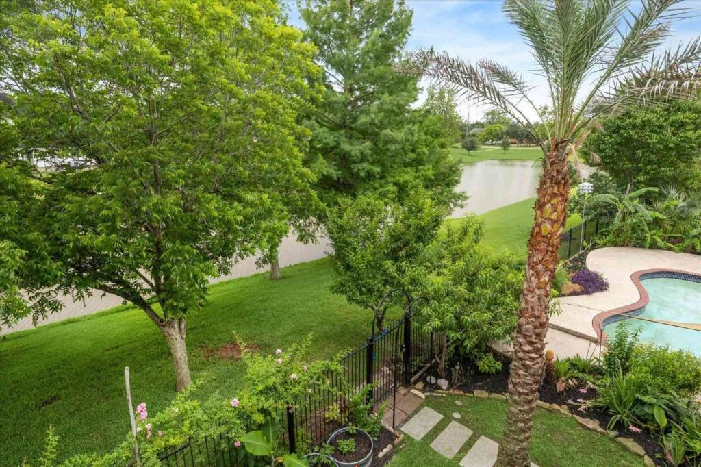 Beautiful backyard with a pool and lake views, a featured property through a local home buying realtor Sugar Land.