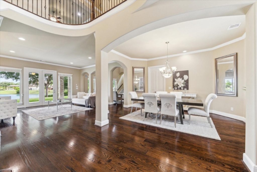 Elegant dining and living room with high ceilings, a luxury home feature from a licensed real estate broker Sugar Land.