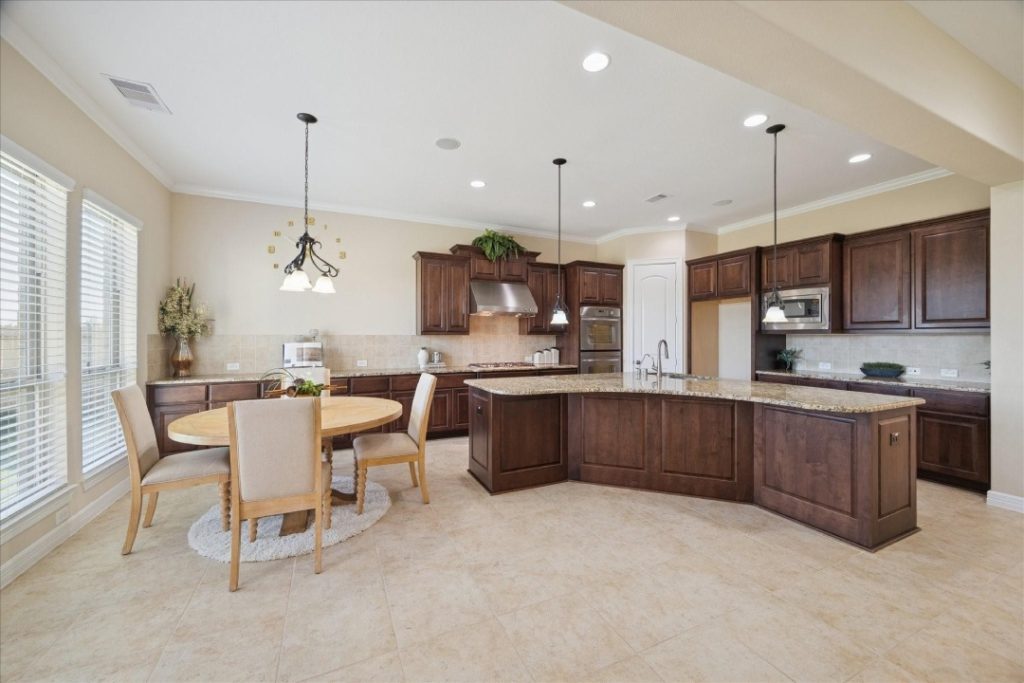 Spacious kitchen with island and breakfast area in a home listed by house selling agents Sugar Land for prospective families.