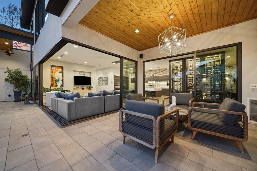 Exquisite view of indoor-outdoor living and a custom wine cellar, a premium feature from a Sugar Land luxury real estate agent portfolio.
