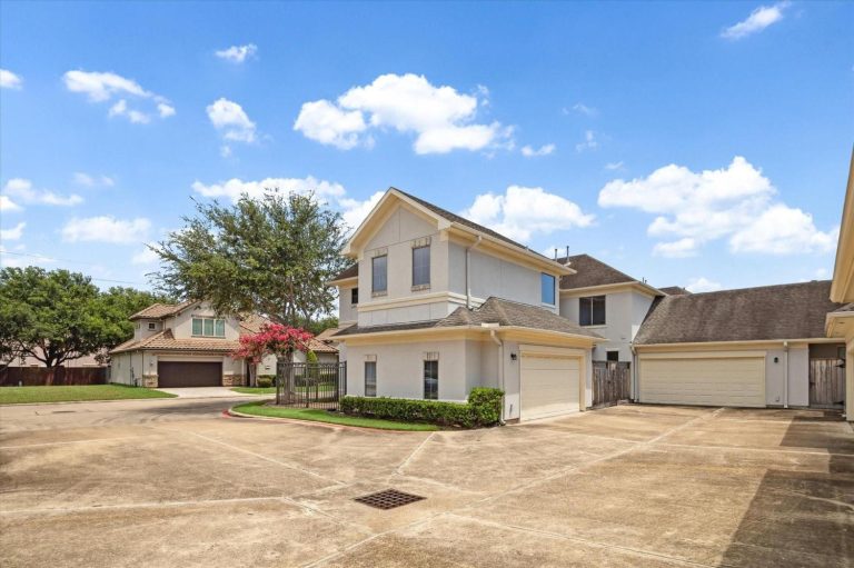 Multiple modern house with large garages on a shared paved driveway in a high-traffic Sugar Land location.