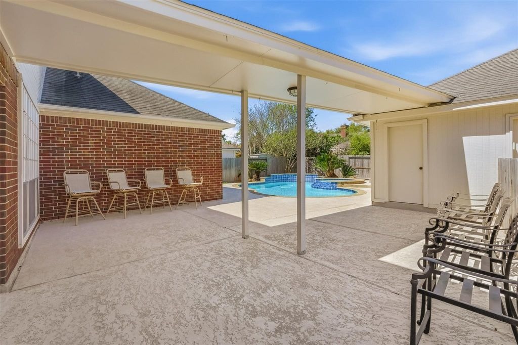 Spacious covered patio and entertaining area overlooking the pool, ideal for a listing with a home selling realtor sugar land.