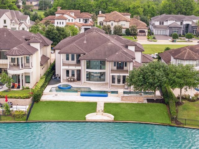 Waterfront Sugar Land home with pool, showing why top house selling agents Sugar Land recommend this luxurious community.