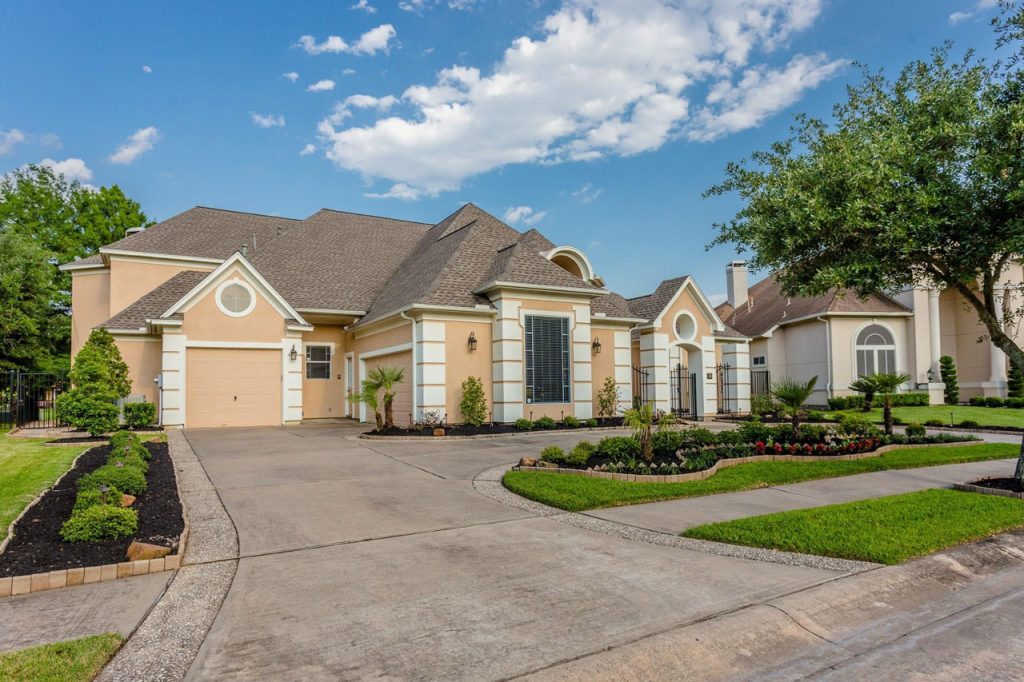 Close-up of the elegant gated courtyard entry of a Sugar Land home, ideal for listing with house selling agents Sugar Land.