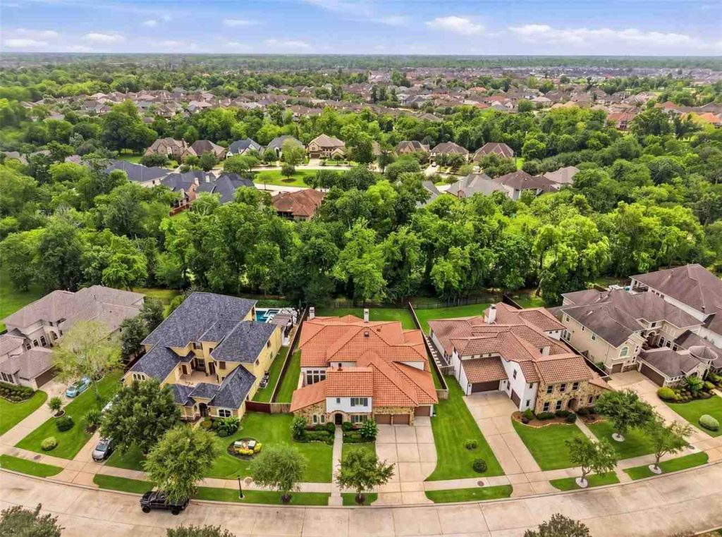 Aerial drone view of a luxurious suburban neighborhood with large homes, perfect for families seeking Lease Properties Sugar Land.
