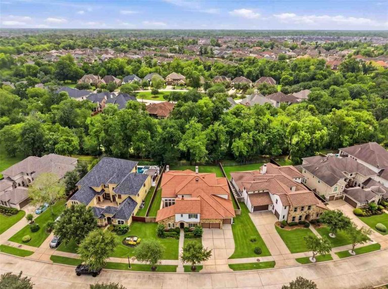 Aerial drone view of a luxurious suburban neighborhood with large homes, perfect for families seeking Lease Properties Sugar Land.
