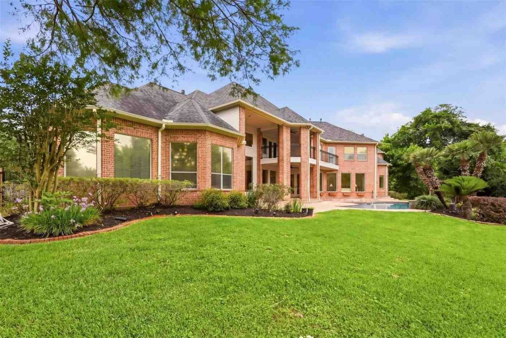 See this massive brick estate with grand balconies and a large patio, available now from your real estate agent Sugar Land team.