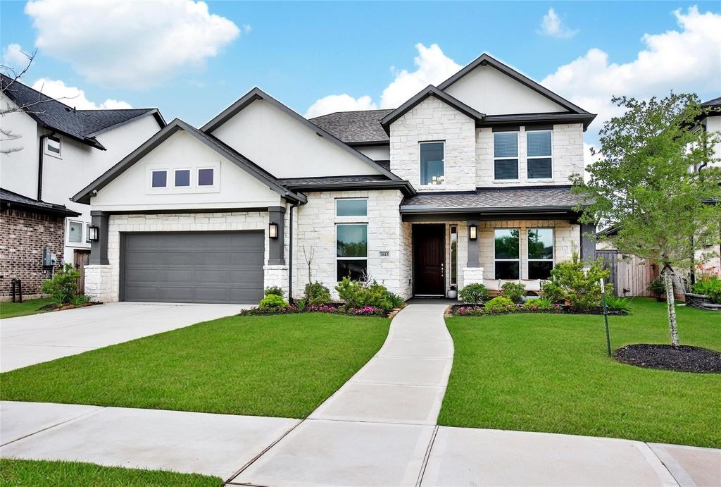 The stunning two-story exterior of a modern house listed by your expert House Selling Agents Sugar Land.