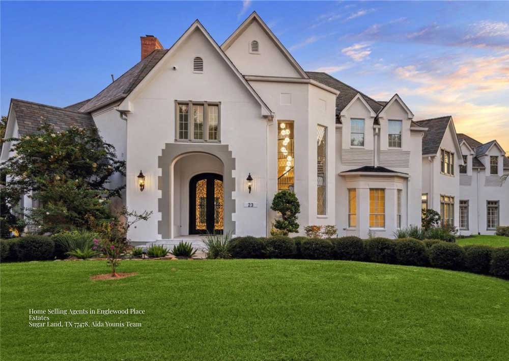 Stunning white mansion front facade showcased by home selling agents Sugar Land at Englewood Place Estates 77478.