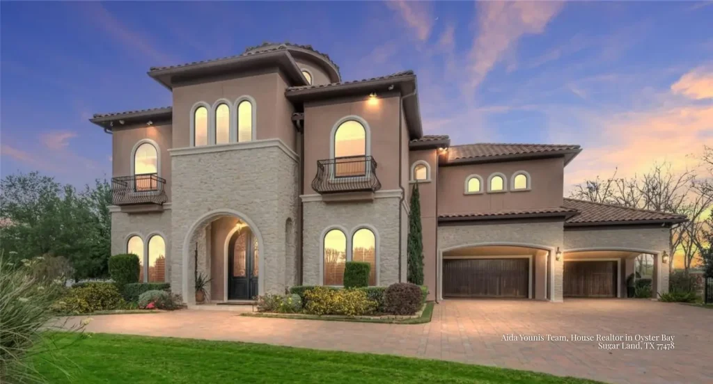 Stunning Oyster Bay estate lit up at twilight, marketed by a trusted house realtor Sugar Land TX real estate expert. 