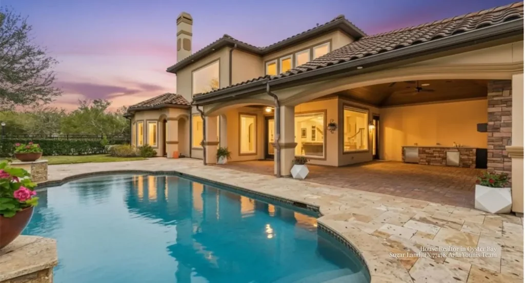Resort-style pool patio and outdoor kitchen at an Oyster Bay home presented by an expert house realtor Sugar Land. 