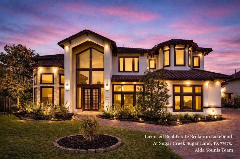 Beautiful twilight view of a luxury stucco estate exterior at Lakebend at Sugar Creek in Sugar Land Texas.