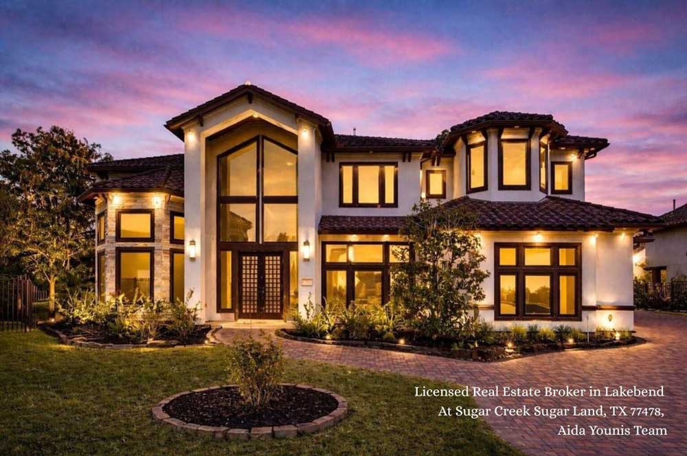 Beautiful twilight view of a luxury stucco estate exterior at Lakebend at Sugar Creek in Sugar Land Texas.