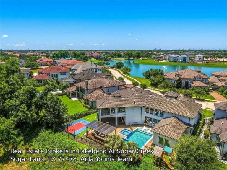 Scenic aerial view of a luxury pool and lake, marketed by expert real estate brokers Sugar Land professionals.