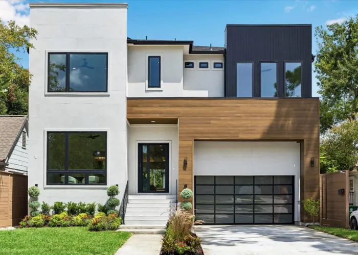 Modern two-story luxury home with wood accents and glass garage at 2526 Southgate Boulevard, Houston, TX 77030.