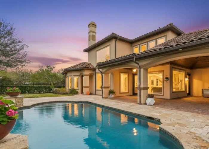 Luxury backyard pool and covered patio at sunset behind 5006 Water View Bend, Sugar Land, TX 77479 estate.