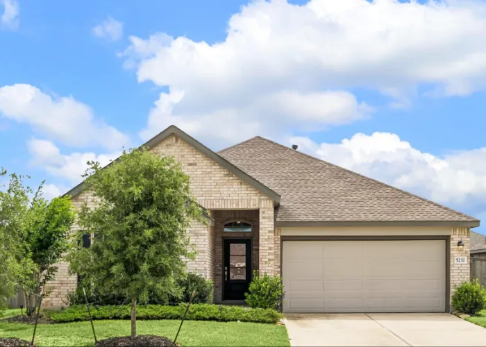 Charming one-story brick home exterior with garage and green lawn at 5232 Pine Pass Drive, Rosenberg, TX 77469.