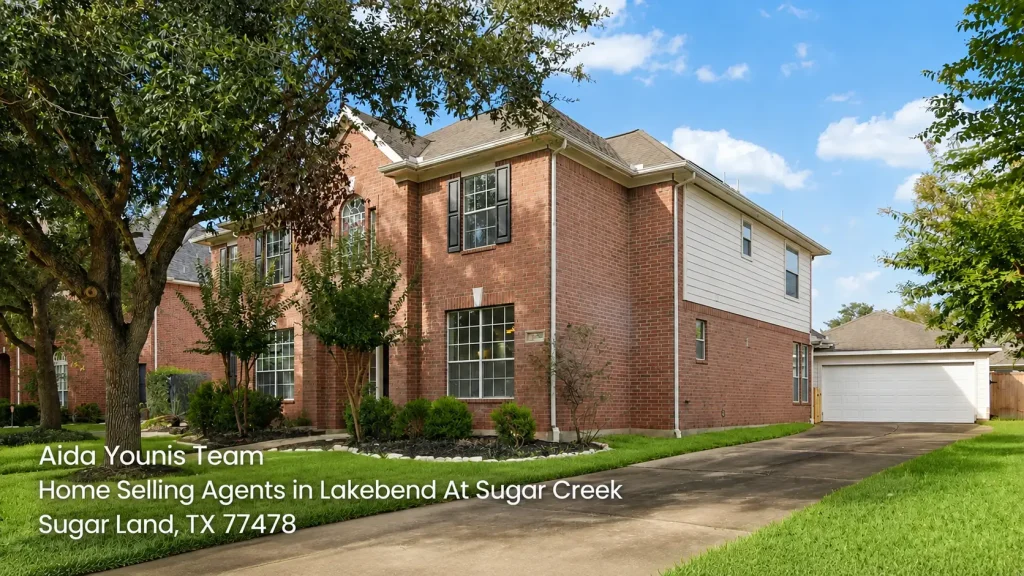 Two-story red brick house in Lakebend At Sugar Creek marketed by premier home selling agents sugar land Aida Younis Team.