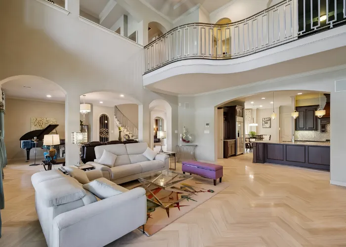 Spacious luxury living room with piano and curved balcony for Houston area open houses this weekend tours.