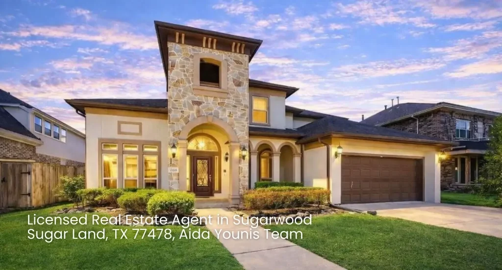 Two-story stone luxury house with front lawn and driveway listed by a licensed real estate agent Sugar Land expert.