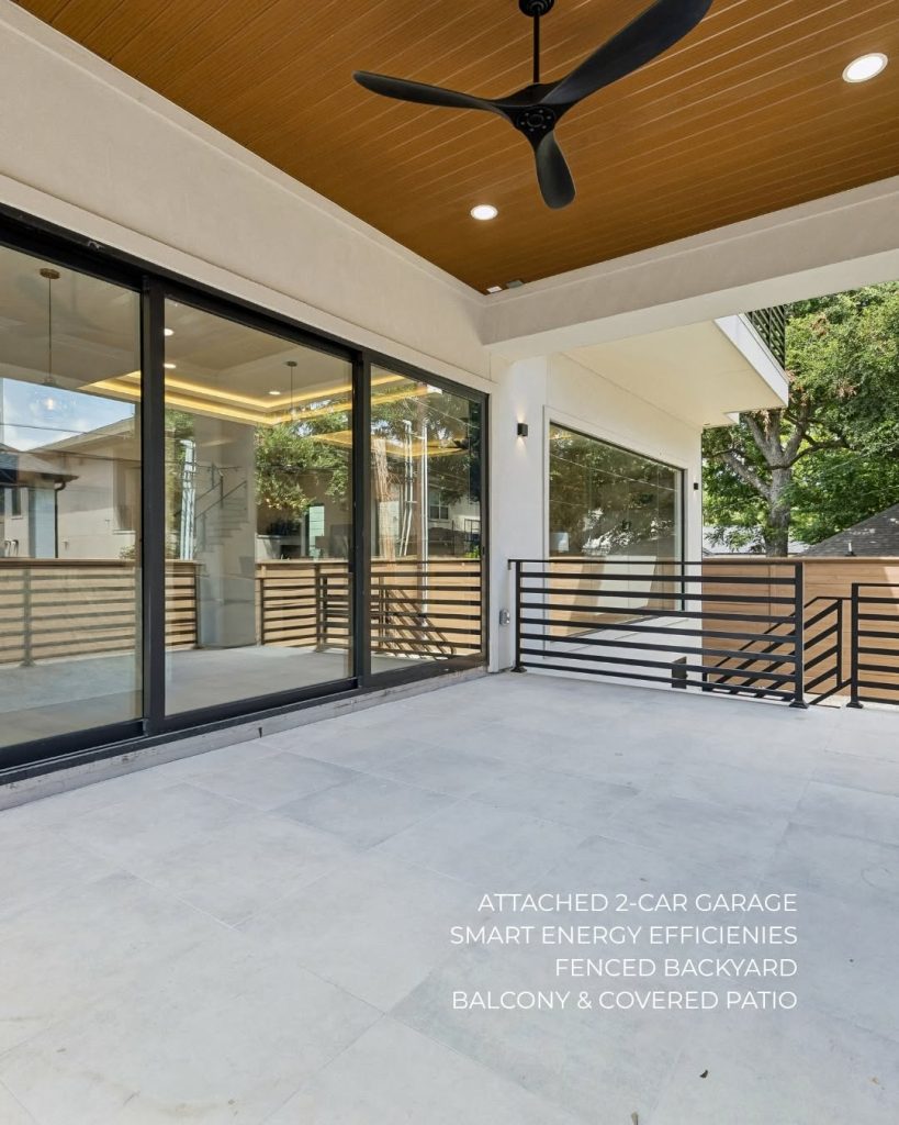 Covered outdoor patio with wood ceiling and modern railings at a new construction home Rice Museum District Houston.
