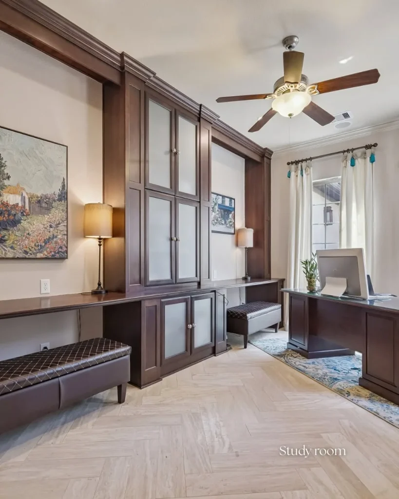 Private study room featuring custom dark wood built-in cabinets in a Riverstone waterfront home for sale.