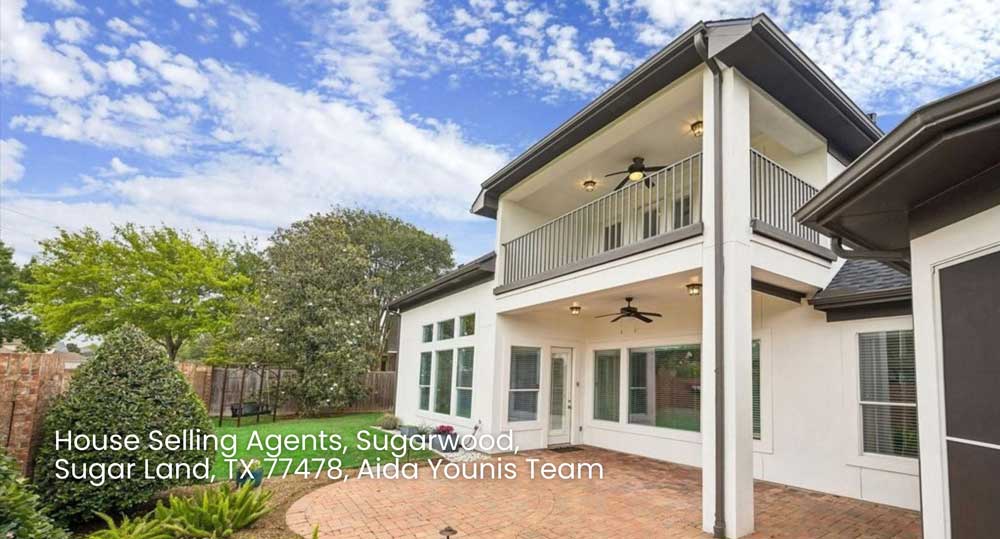Spacious backyard patio and balcony of a luxury residential home listed by house selling agents Sugar Land TX.