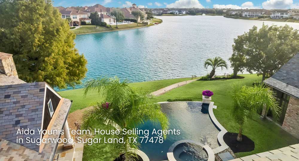 Aerial view of waterfront luxury home with swimming pool listed by house selling agents Sugar Land in Sugarwood.