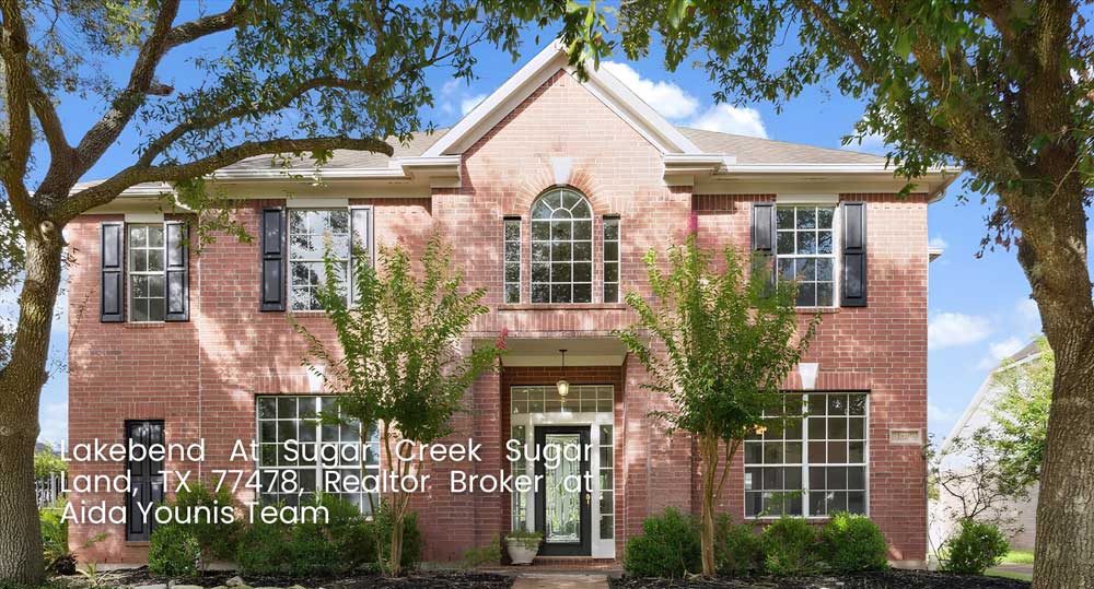 Two-story red brick home in Lakebend At Sugar Creek by realtor broker Sugar Land Aida Younis Team in TX 77478.