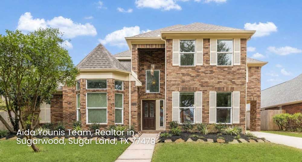 Front lawn and driveway view of a classic Mediterranean style estate home from a realtor Sugar Land TX.